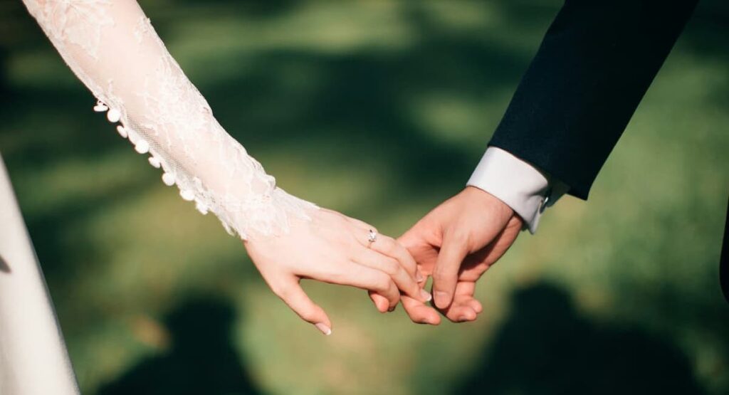bride and groom holding hands